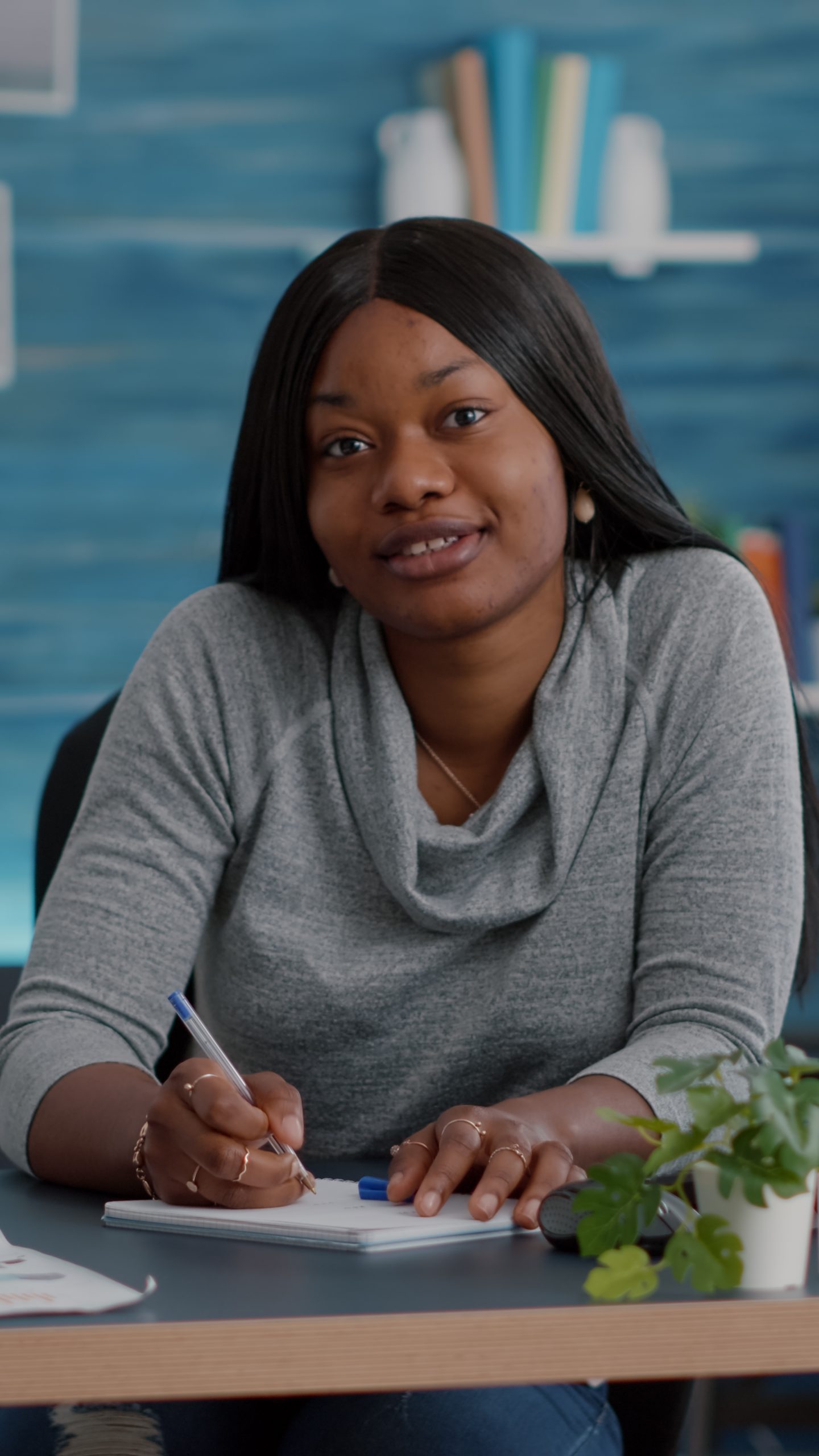 Point of view of student with dark skin smiling at camera during communication videocall
